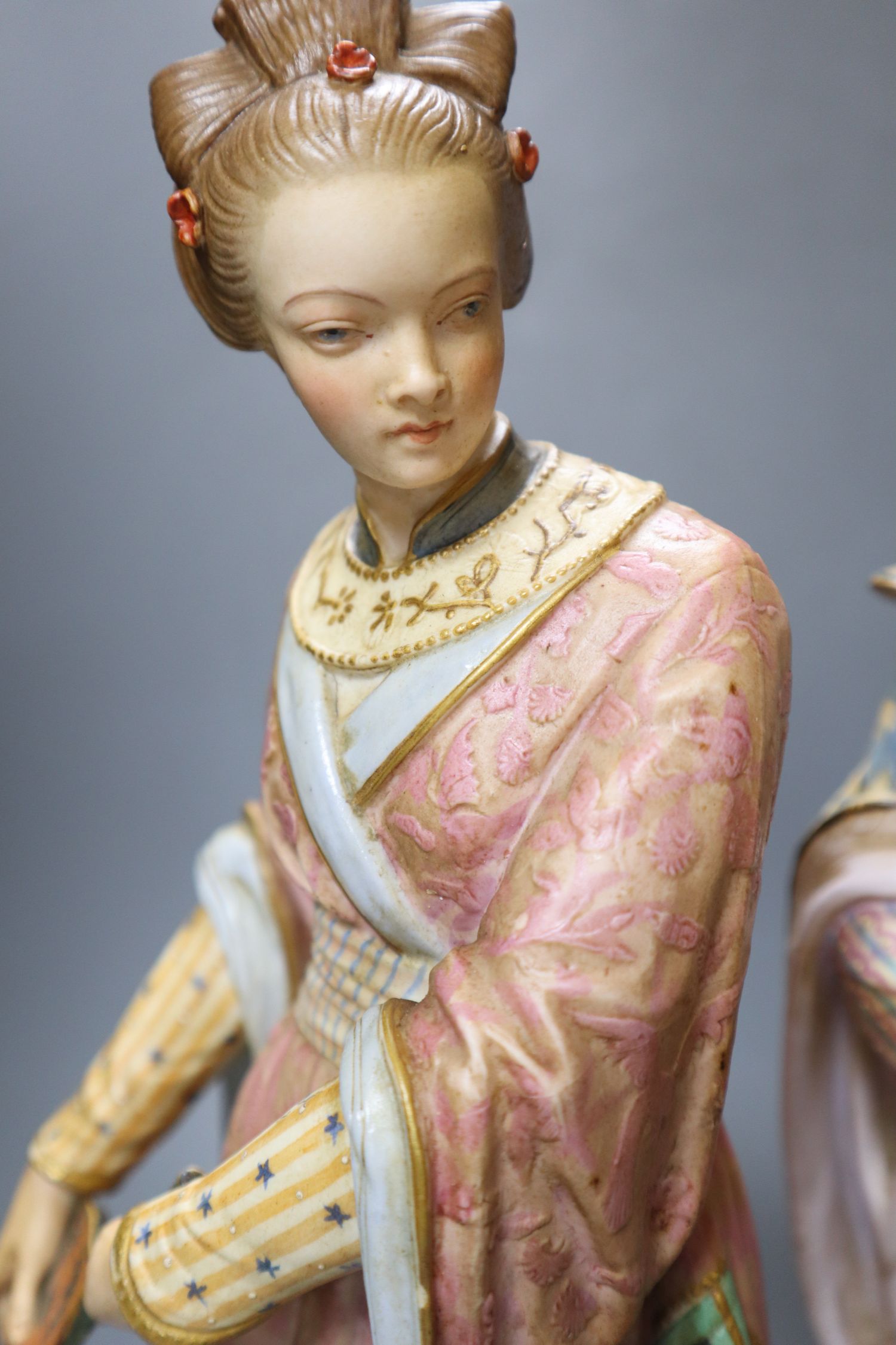 A pair of 19th century coloured bisque porcelain Oriental figures, height 38cm